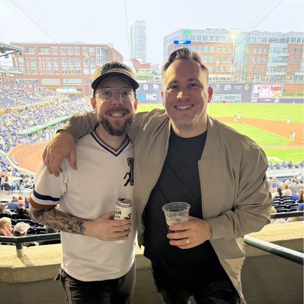 Two Ballpark teammates posing together overlooking a baseball field
